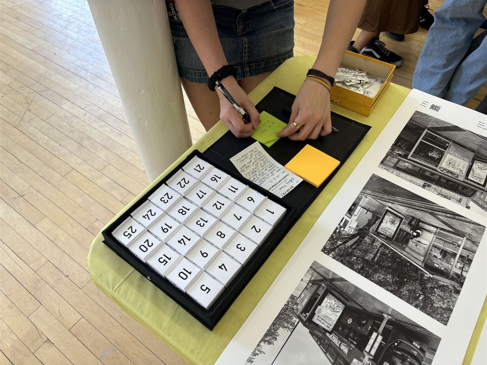 Exhibition view of the opened box with a visitor's feedback note